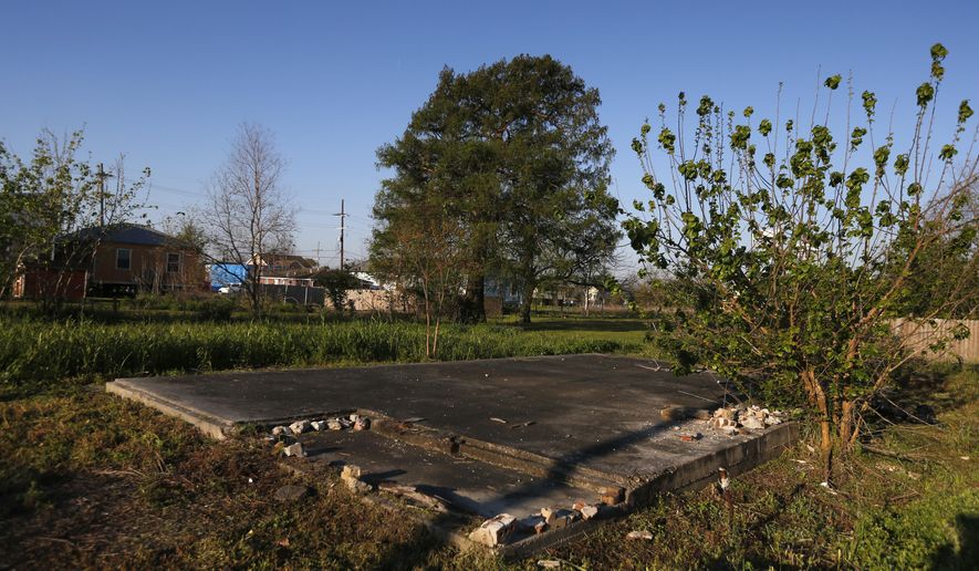 In this Thursday, March 16, 2017 photo, a slab of a former home sits in an empty lot in the Lower 9th Ward in New Orleans. A major rebuilding project is set to bring hundreds of new residents into the neighborhood, in what developers, officials and some residents hope will mark an important turning point. But others have concerns about the new development and whether it's the right fit for the historic, African-American neighborhood. (AP Photo/Gerald Herbert)