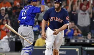 Houston Astros designated hitter Evan Gattis tosses his bat after drawing a bases-loaded walk to score George Springer and win the baseball game against the Kansas City Royals in twelve innings, Sunday, April 9, 2017, in Houston. (AP Photo/Eric Christian Smith)