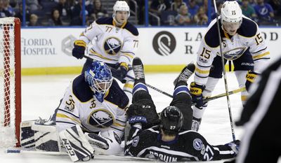 Buffalo Sabres center Jack Eichel (15)knocks down Tampa Bay Lightning left wing Jonathan Drouin (27) on top of goalie Linus Ullmark (35) during the second period of an NHL hockey game, Sunday, April 9, 2017, in Tampa, Fla. (AP Photo/Chris O&#39;Meara)
