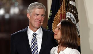 In this Tuesday, Jan. 31, 2017, file photo, Judge Neil Gorsuch stands with his wife Marie Louise Gorsuch as President Donald Trump announces him as his choice for the Supreme Court in the East Room of the White House in Washington. (AP Photo/Carolyn Kaster, File)