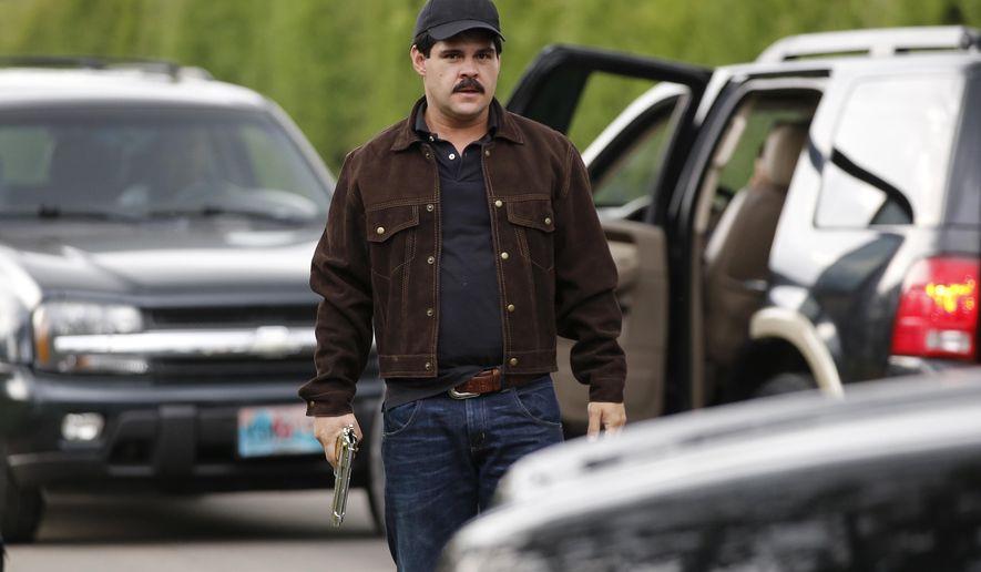 In this March, 21, 2017 photo, Mexican actor Marco de la O plays drug trafficker Joaquin Guzman during the filming of "El Chapo" in Tabio, Colombia. The life of the Mexican drug kingpin is being brought to television screens in a drama co-produced by Netflix and Univision. (AP Photo/Fernando Vergara)