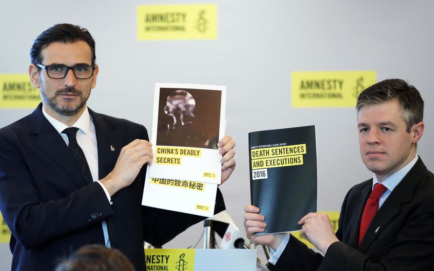 In this Monday, April 10, 2017 photo, Amnesty International East Asia Director Nicholas Bequelin, left, and Deputy Director of Global Issues James Lynch hold the copies of reports on the death penalty during a press conference in Hong Kong. Human rights activists say China&#x27;s use of the death penalty remains shrouded in secrecy and still outpaces the rest of the world combined, even after the nation&#x27;s execution rate fell sharply in recent years. (AP Photo/Kin Cheung)