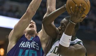 Milwaukee Bucks&#39; Thon Maker is fouled by Charlotte Hornets&#39; Cody Zeller during the second half of an NBA basketball game Monday, April 10, 2017, in Milwaukee. (AP Photo/Tom Lynn)
