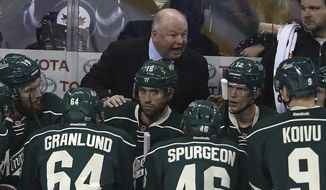 FILE - In this March 19, 2017, file photo, Minnesota Wild coach Bruce Boudreau speaks to his team during a timeout in the first period of an NHL hockey game against the Winnipeg Jets in Winnipeg, Manitoba. Longtime coach and former player Bruce Boudreau has connections in some way to every playoff team, some closer than others. “There’s a lot of pride in players that you coached,” Boudreau said .(Trevor Hagan/The Canadian Press via AP, File)
