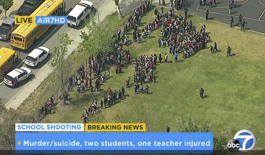 In this frame from video provided by KABC-TV, faculty and students evacuate North Park School Elementary School as emergency personnel respond to a shooting inside on Monday, April 10, 2017, in San Bernardino, Calif. (KABC-TV via AP)