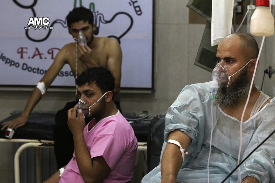 FILE - In this Tuesday, Sept. 6, 2016 file photo, provided by the Syrian anti-government activist group Aleppo Media Center (AMC), shows men breathing with oxygen masks inside a hospital in Aleppo, Syria. With its missile strike on Shayrat Airbase in central Syria, Washington signaled that it had judged President Bashar Assad responsible for the horrific chemical weapons attack in north Syria that drew international outrage last week. But it is not the first or even deadliest atrocity of the war.  (Aleppo Media Center via AP, File)
