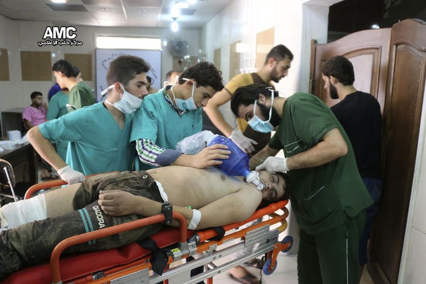 FILE - In this Tuesday, Sept. 6, 2016 file photo, provided by the Syrian anti-government activist group Aleppo Media Center (AMC), shows medical staff treating a man suffering from breathing difficulties inside a hospital in Aleppo, Syria. With its missile strike on Shayrat Airbase in central Syria, Washington signaled that it had judged President Bashar Assad responsible for the horrific chemical weapons attack in north Syria that drew international outrage last week. But it is not the first or even deadliest atrocity of the war. (Aleppo Media Center via AP, File)