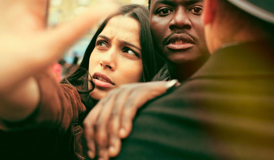 This image released by Showtime shows Freida Pinto, left, Babou Ceesay in a scene from, "Guerrilla," written and produced by John Ridley. Ridley said he expected his "sharply political" TV miniseries "Guerrilla," about black rights activists in 1970s England, to be provocative. But the criticism he received at a London screening for the series' lack of a major black female character took him by surprise, he said Monday, April 10. (Showtime via AP)