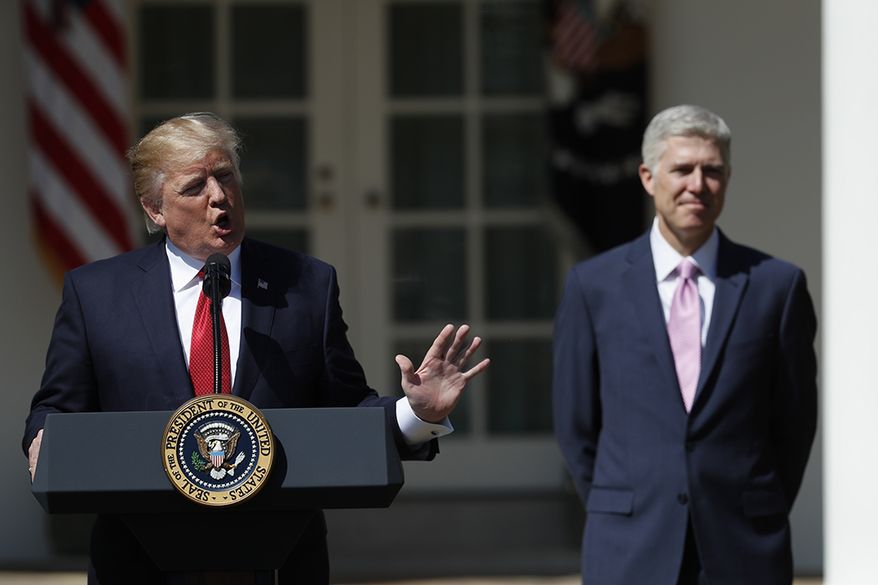Supreme Court Justice Neil Gorsuch listens as President Donald Trump speaks in the Rose Garden of the White House White House in Washington, Monday, April 10, 2017, before a public swearing-in ceremony for Gorsuch. (AP Photo/Carolyn Kaster)