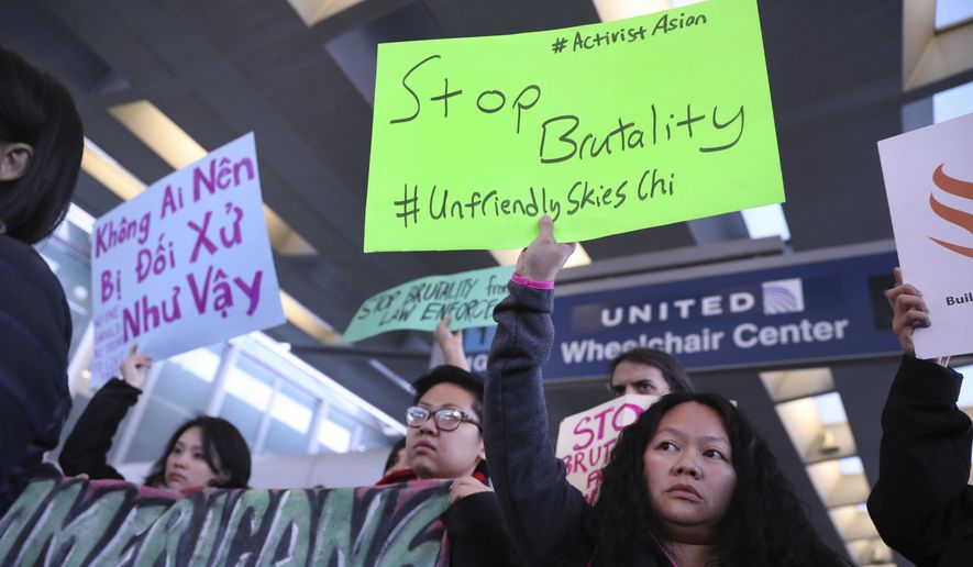 People with Asian community organizations from Chicago hold signs to protest after Sunday&#39;s confrontation where David Dao, 69, of Elizabethtown, Ky., was removed from a United Airlines airplane by Chicago airport police at O&#39;Hare International Airport, during rally near United&#39;s counter at the airport&#39;s Terminal 1 in Chicago on Tuesday, April 11, 2017. (Chris Sweda/Chicago Tribune via AP)