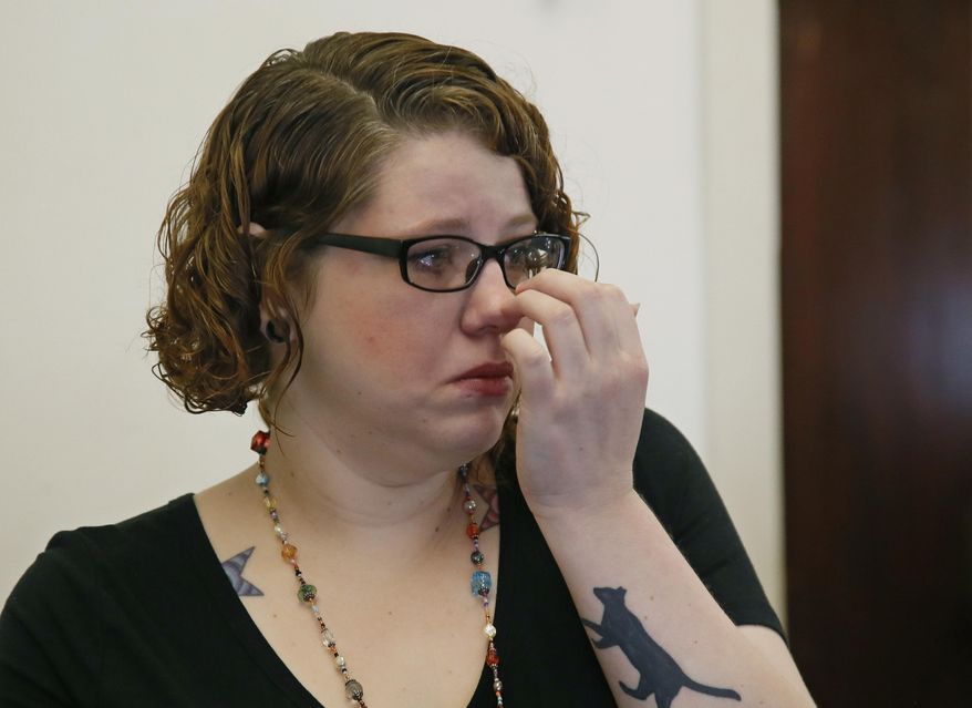 In this Monday, April 10, 2017 photo, Derina Soles fights back tears during an interview in Oklahoma City. After years of trying unsuccessfully to have a baby, Soles said she was excited to attend her first ultrasound and find out the gender of her new baby. Soles learned her fetus had anencephaly, a rare and untreatable defect in which a baby's brain and skull don't form properly, and made the decision to terminate the pregnancy. (AP Photo/Sue Ogrocki)