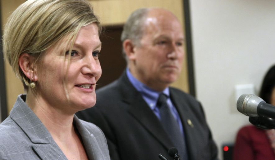 FILE - In this June 28, 2016, file photo Jahna Lindemuth, left, speaks after being introduced by Gov. Bill Walker, right, as the state's new attorney general, subject to legislative approval. Lindemuth could be in for a fight in her bid for confirmation Wednesday, April 12, 2017, over her handling of land access issues. (AP Photo/Mark Thiessen)