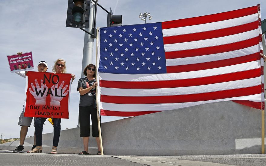 Protesters gather outside of a news conference where Attorney General Jeff Sessions spoke after he toured the U.S.-Mexico border with border officials, Tuesday, April 11, 2017, in Nogales, Ariz. Sessions announced making immigration enforcement a key Justice Department priority, saying he will speed up deportations of immigrants in the country illegally who were convicted of federal crimes. (AP Photo/Ross D. Franklin)