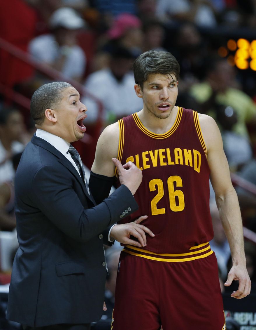 Cleveland Cavaliers head coach Tyronn Lue talks with guard Kyle Korver (26) during overtime in an NBA basketball game against the Miami Heat, Monday, April 10, 2017, in Miami. The Heat defeated the Cavaliers 124-121 in overtime. (AP Photo/Wilfredo Lee)