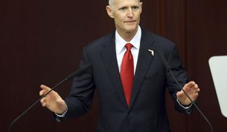 FILE - In this Tuesday, March 7, 2017, file photo, Gov. Rick Scott makes the state of the state address to the joint session of the legislature in Tallahassee, Fla. State Attorney Aramis Ayala has fired a double-barreled response to Scott’s efforts to take away almost two-dozen cases after she said her office would no longer seek the death penalty. Ayala on Tuesday, April 11, 2017, filed lawsuits in state and federal courts, challenging Scott’s ability to remove her from death-penalty cases. (AP Photo/Steve Cannon, File)