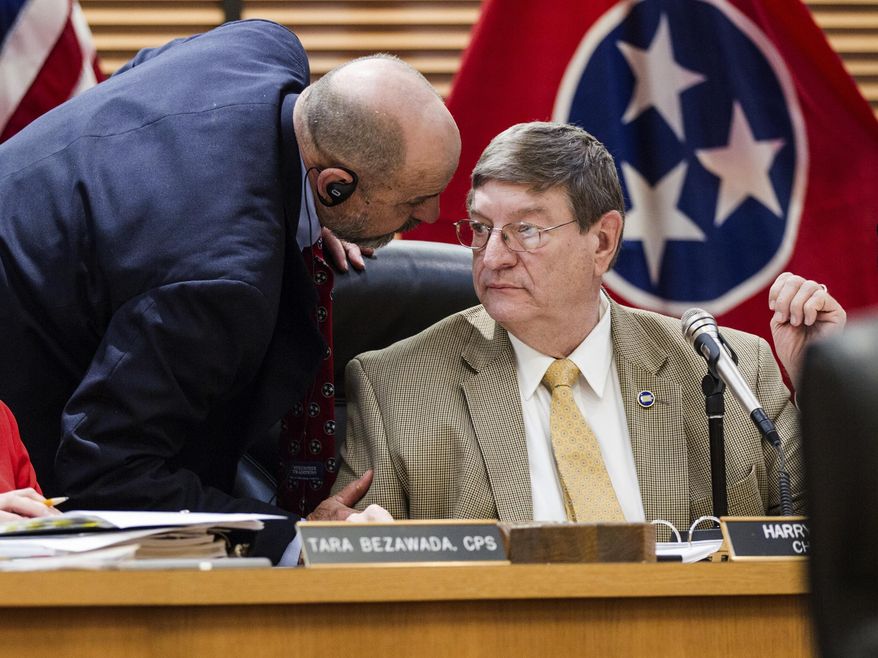 Chairman Harry Brooks, R-Knoxville, right, and Rep. Ron Lollar, R-Bartlett, confer during the debate over a bill seeking offer in-state tuition rates to public college students whose parents brought them to the country illegally in Nashville, Tenn., on Tuesday, April 11, 2017. The measure was narrowly defeated in the House Education Administration and Planning Committee, with Brooks voting in favor and Lollar voting against. (AP Photo/Erik Schelzig)