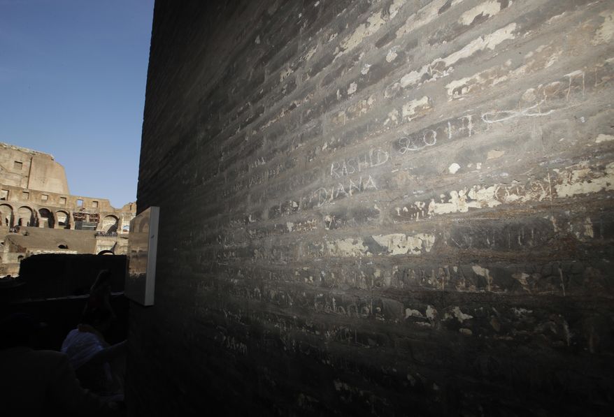 A view of a writing inscribed on a wall inside the Colosseum, Tuesday, April 11, 2017. Italian police say a tourist from Ecuador has been cited for inscribing the name of his son and wife and the year, 2017, on Monday, April 10, 2017 inside the ancient Roman Colosseum. Carabinieri Major Lorenzo Iacobone said the tourist was observed in the act of vandalism by an official tour guide, who reported it to police. (AP Photo/Alessandra Tarantino)