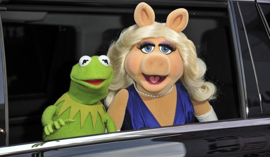FILE- In this March 11, 2014, file photo, Kermit the Frog, left, and Miss Piggy arrive at the World Premiere of "Muppets Most Wanted," in Los Angeles. A New York City museum is asking fans of Jim Henson's Muppets to help pay for an exhibition featuring original puppets of beloved characters like Elmo, Miss Piggy and Kermit the Frog.The Museum of the Moving Image launched a Kickstarter campaign Tuesday, April 11, 2017, seeking $40,000 to help preserve the puppets for posterity. (Photo by Richard Shotwell/Invision/AP, File)