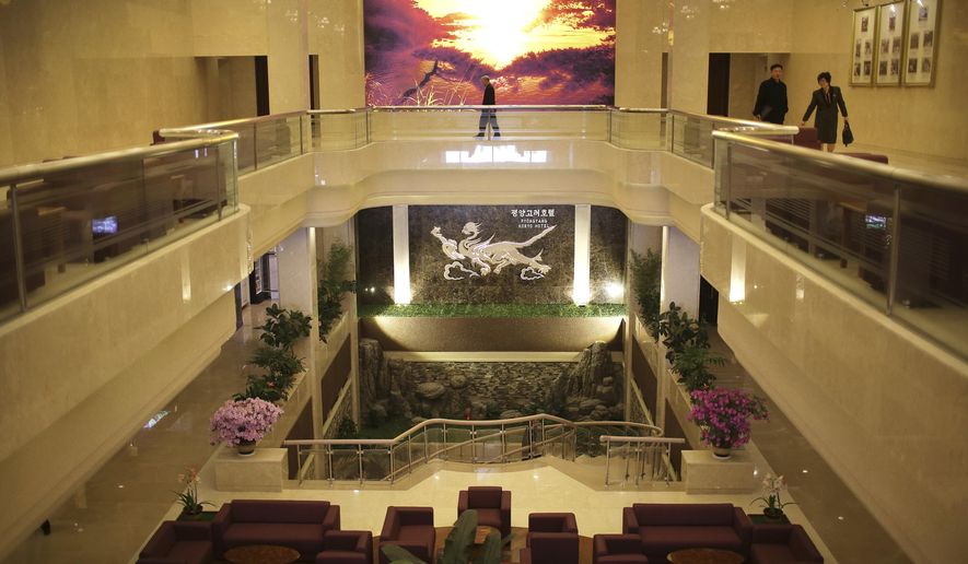 In this Monday, April 10, 2017, photo, people walk on the second floor above the lobby of the newly renovated Koryo hotel in Pyongyang, North Korea. The country's most famous luxury hotel reopened this week after renovations. With its twin towers in the center of the city, the Koryo has for decades been one of Pyongyang's best-known and most visible landmarks. (AP Photo/Wong Maye-E)