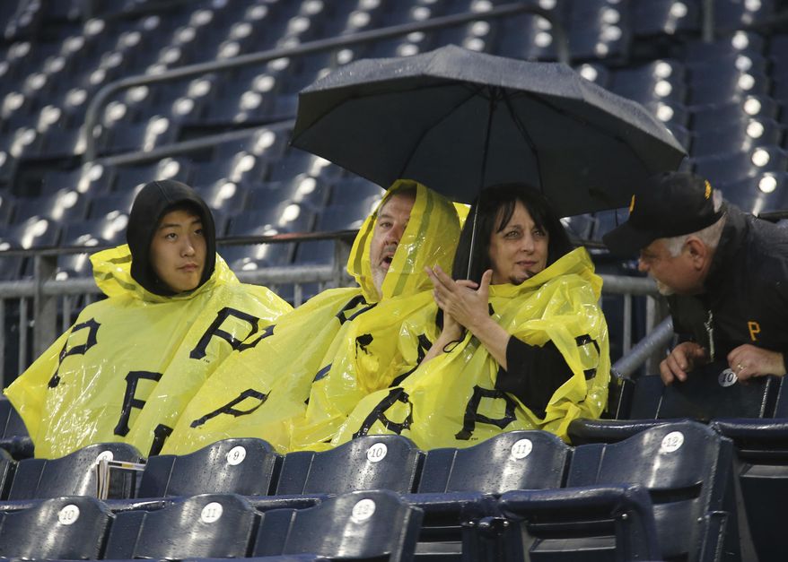 Pittsburgh Pirates fans talk with an usher during a rain delay before a baseball game between the Pittsburgh Pirates and the Cincinnati Reds, Tuesday, April 11, 2017, in Pittsburgh. (AP Photo/Keith Srakocic)