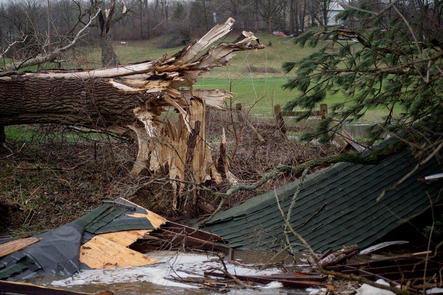 A large downed tree lays near the destroyed covered bridge at Tyler Creek Golf Course and Campground off of 92nd Street between Wingeier Avenue and Hastings Road in Alt, Mich., Tuesday, April 11, 2017. Authorities say severe thunderstorms Monday night spawned a suspected tornado in western Michigan, knocking down a barn and blocking roadways with debris. (Neil Blake/The Grand Rapids Press via AP)