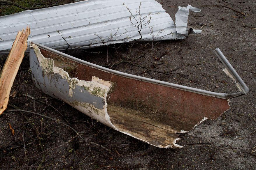 A piece of a canoe in debris is seen at Tyler Creek Golf Course and Campground off of 92nd Street between Wingeier Avenue and Hastings Road in Alto, Mich., Tuesday, April 11, 2017.Authorities say severe thunderstorms Monday night spawned a suspected tornado in western Michigan, knocking down a barn and blocking roadways with debris. (Neil Blake/The Grand Rapids Press via AP)