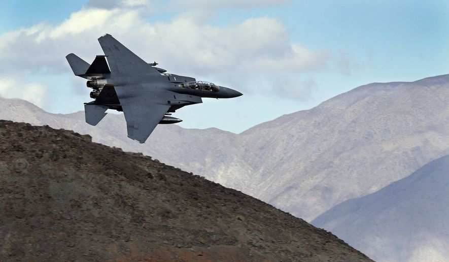 In this Feb. 27, 2017, photo an F-15E Strike Eagle from Seymour Johnson AFB in North Carolina flies out of the nicknamed Star Wars Canyon turning toward the Panamint range over Death Valley National Park, Calif. Military jets roaring over national parks have long drawn complaints from hikers and campers. But in California's Death Valley, the low-flying combat aircraft skillfully zipping between the craggy landscape has become a popular attraction in the 3.3 million acre park in the Mojave Desert, 260 miles east of Los Angeles. (AP Photo/Ben Margot)