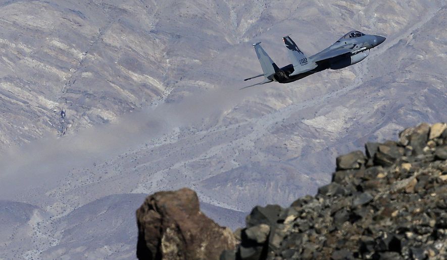 In this Feb. 28, 2017, photo, an F-15C Eagle from the California Air National Guard, 144th Fighter Wing, flies out of the nicknamed Star Wars Canyon over Death Valley National Park, Calif. Military jets roaring over national parks have long drawn complaints from hikers and campers. But in California&#39;s Death Valley, the low-flying combat aircraft skillfully zipping between the craggy landscape has become a popular attraction in the 3.3 million acre park in the Mojave Desert, 260 miles east of Los Angeles. (AP Photo/Ben Margot)