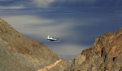 In this Feb. 27, 2017, photo a Beechcraft T-6 Texan II trainer from Sheppard AFB Texas flies out of the nicknamed Star Wars Canyon while on the Jedi transition over Death Valley National Park, Calif. Military jets roaring over national parks have long drawn complaints from hikers and campers. But in California&#x27;s Death Valley, the low-flying combat aircraft skillfully zipping between the craggy landscape has become a popular attraction in the 3.3 million acre park in the Mojave Desert, 260 miles east of Los Angeles. (AP Photo/Ben Margot)