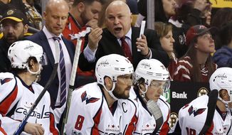 Washington Capitals coach Barry Trotz talks to his players during the third period of Washington&#x27;s 3-1 win over the Boston Bruins in an NHL hockey game in Boston on Saturday, April 8, 2017. (AP Photo/Winslow Townson)