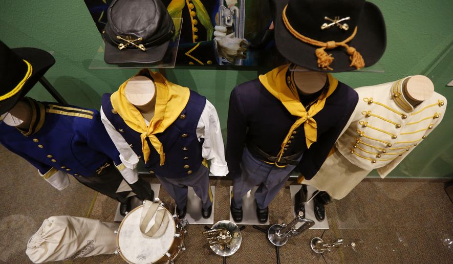 In a Tuesday, April 4, 2017 photo, a selection of Troopers Drum & Bugle Corps uniforms from years past are included in an exhibit at Fort Caspar Museum in Casper, Wyo. (Alan Rogers/The Casper Star-Tribune via AP)