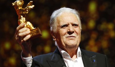 FILE - In this Feb. 18, 2016 file photo German cinematographer Michael Ballhaus shows the Honorary Golden Bear after being awarded for his lifetime achievement during the awarding ceremony at the 2016 Berlinale Film Festival in Berlin, Germany. Ballhaus has died. He was 81. (AP Photo/Axel Schmidt, file)
