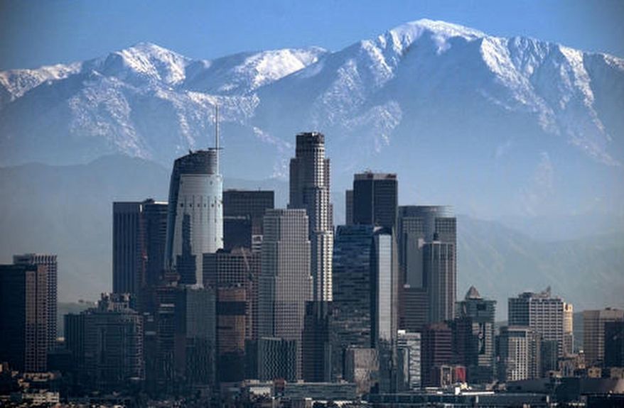 This Jan. 25, 2017 file photo shows a snow-covered Mount Baldy, the highest peak among the San Gabriel Mountains behind downtown Los Angeles. (AP Photo/Richard Vogel, File)