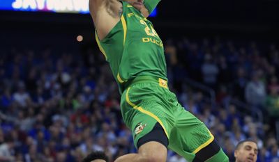 FILE- In this March 25, 2017, file photo, Oregon forward Dillon Brooks (24) dunks the ball over Kansas defenders Frank Mason III (0) and Landen Lucas (33) during the first half of a regional final of the NCAA men&#x27;s college basketball tournament in Kansas City, Mo. Brooks has announced that he will declare for the NBA draft. (AP Photo/Orlin Wagner, File)