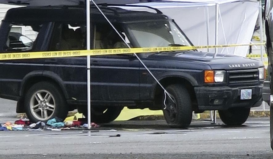 An SUV is shown in Portland, Ore, Wednesday, April 12, 2017, where a man and his two young daughters died early Wednesday. An Oregon man and his two young daughters died after police got word he was threatening the girls, leading to a shootout with officers. (AP Photo/Gillian Flaccus)
