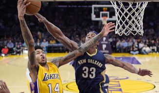 Los Angeles Lakers forward Brandon Ingram, left, shoots as New Orleans Pelicans forward Dante Cunningham defends during the first half of an NBA basketball game, Tuesday, April 11, 2017, in Los Angeles. (AP Photo/Mark J. Terrill)