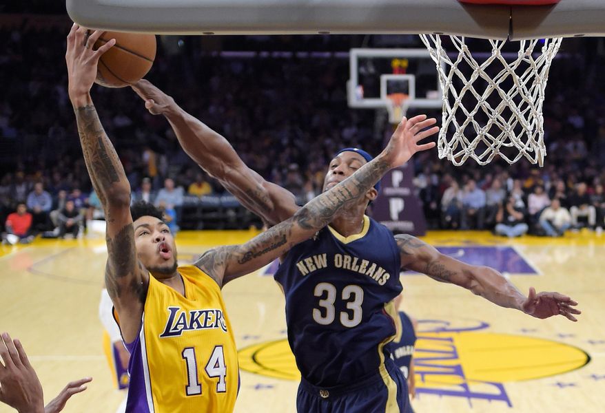 Los Angeles Lakers forward Brandon Ingram, left, shoots as New Orleans Pelicans forward Dante Cunningham defends during the first half of an NBA basketball game, Tuesday, April 11, 2017, in Los Angeles. (AP Photo/Mark J. Terrill)