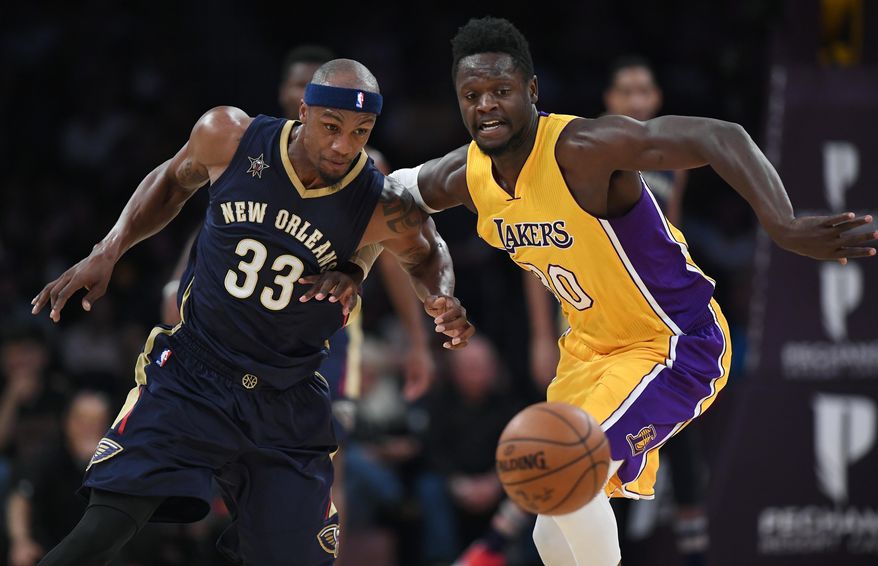 New Orleans Pelicans forward Dante Cunningham, left, and Los Angeles Lakers forward Julius Randle go after a loose ball during the first half of an NBA basketball game, Tuesday, April 11, 2017, in Los Angeles. (AP Photo/Mark J. Terrill)