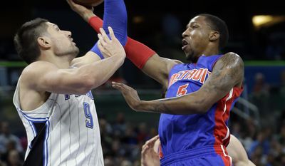 Detroit Pistons&#x27; Kentavious Caldwell-Pope, right, goes up for a shot past Orlando Magic&#x27;s Nikola Vucevic (9) during the first half of an NBA basketball game, Wednesday, April 12, 2017, in Orlando, Fla. (AP Photo/John Raoux)