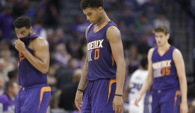 Phoenix Suns forward Marquese Chriss, center, walks off the court during a timeout in the closing moments of the Suns 129-104 loss to the Sacramento Kings during in an NBA basketball game Tuesday, April 11, 2017, in Sacramento, Calif. (AP Photo/Rich Pedroncelli)