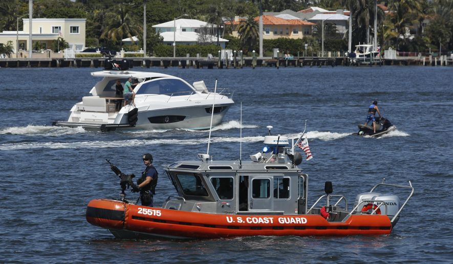 FILE - In this March 19, 2017 file photo, U.S. Coast Guard patrol Lake Worth Lagoon as President Donald Trump returns to his Mar-a-Lago estate in Palm Beach, Fla. It’s widely estimated that each trip to the resort costs taxpayers $3 million, based on a government study of the cost of a 2013 trip to Florida by President Barack Obama. But that trip was more complicated and the study’s author says it can’t be used to calculate the cost of Trump’s travel. This weekend, Trump is making his seventh visit to Mar-a-Lago since becoming president.  (AP Photo/Manuel Balce Ceneta, File)