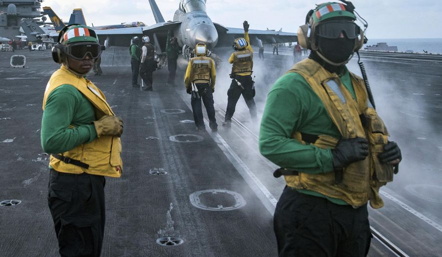 In this photo provided by the U.S. Navy, sailors conduct flight operations on the aircraft carrier USS Carl Vinson (CVN 70) flight deck in April 8, 2017.  The Trump administration deployed an aircraft carrier to the region this week in a show of force that also could expose American weakness. If the North proceeds with a ballistic missile or nuclear test and the U.S. does nothing in response, America’s deterrence will appear diminished. The USS Carl Vinson is steaming to waters off the Korean Peninsula as anticipation mounts that Kim Jong Un will stage another weapons test around the anniversary of the nation’s founder on Saturday.(Mass Communication Specialist 3rd Class Matt Brown/U.S. Navy via AP)