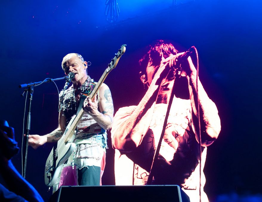 Red Hot Chili Peppers bassist Flea (left) and a projection of singer Anthony Kiedis. (Erica Bruce)