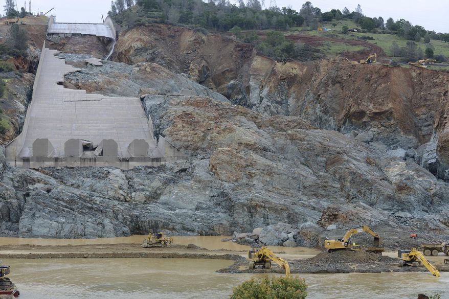 FILE - In this April 6, 2017, file photo, crews work near the Oroville Dam spillway in Oroville, Calif. With stormy weather approaching, California plans to resume releasing water down the damaged spillway at the nation's tallest dam. (Dan Reidel/The Chico Enterprise-Record via AP, File)