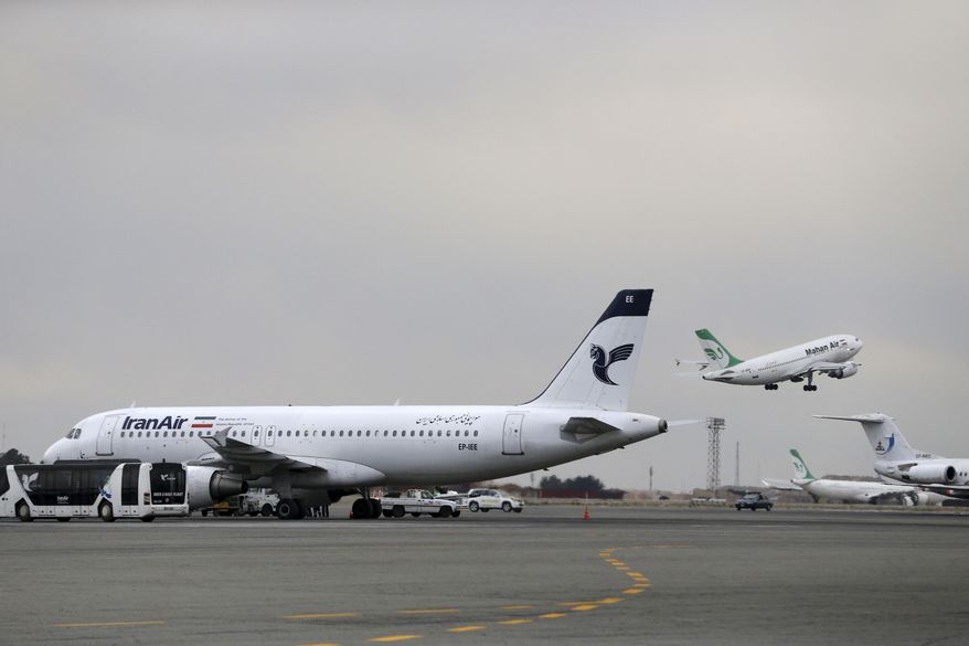 FILE - In this Feb. 7, 2016, file photo, an Iranian Mahan Air passenger plane takes off as a plane of Iran's national air carrier Iran Air, left, is parked at Mehrabad airport in Tehran, Iran. European airplane manufacturer ATR said it signed a deal with Iran Air for 20 aircraft with option for 20 more on Thursday, April 13, 2017. (AP Photo/Vahid Salemi, File)