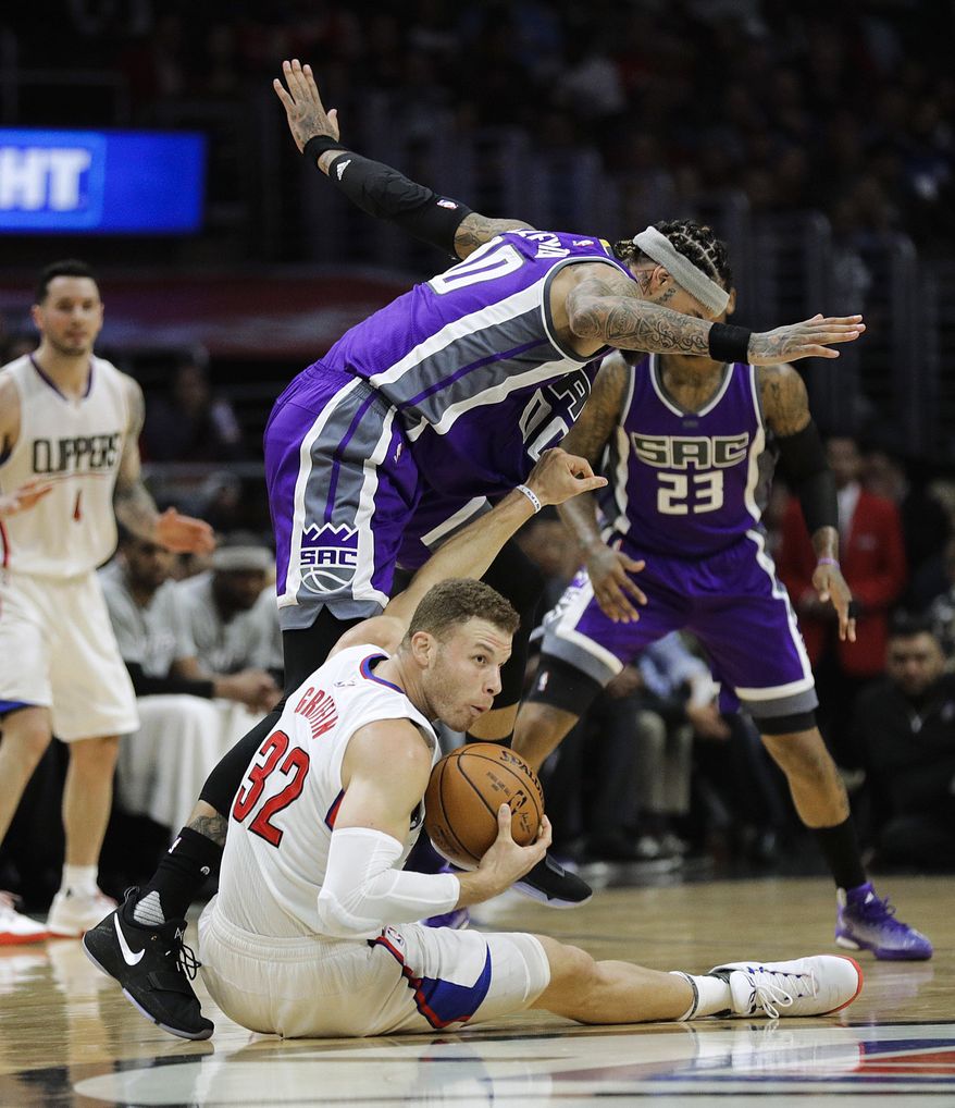 Los Angeles Clippers' Blake Griffin, bottom, grabs a loose ball against Sacramento Kings' Willie Cauley-Stein during the first half of an NBA basketball game Wednesday, April 12, 2017, in Los Angeles. (AP Photo/Jae C. Hong)