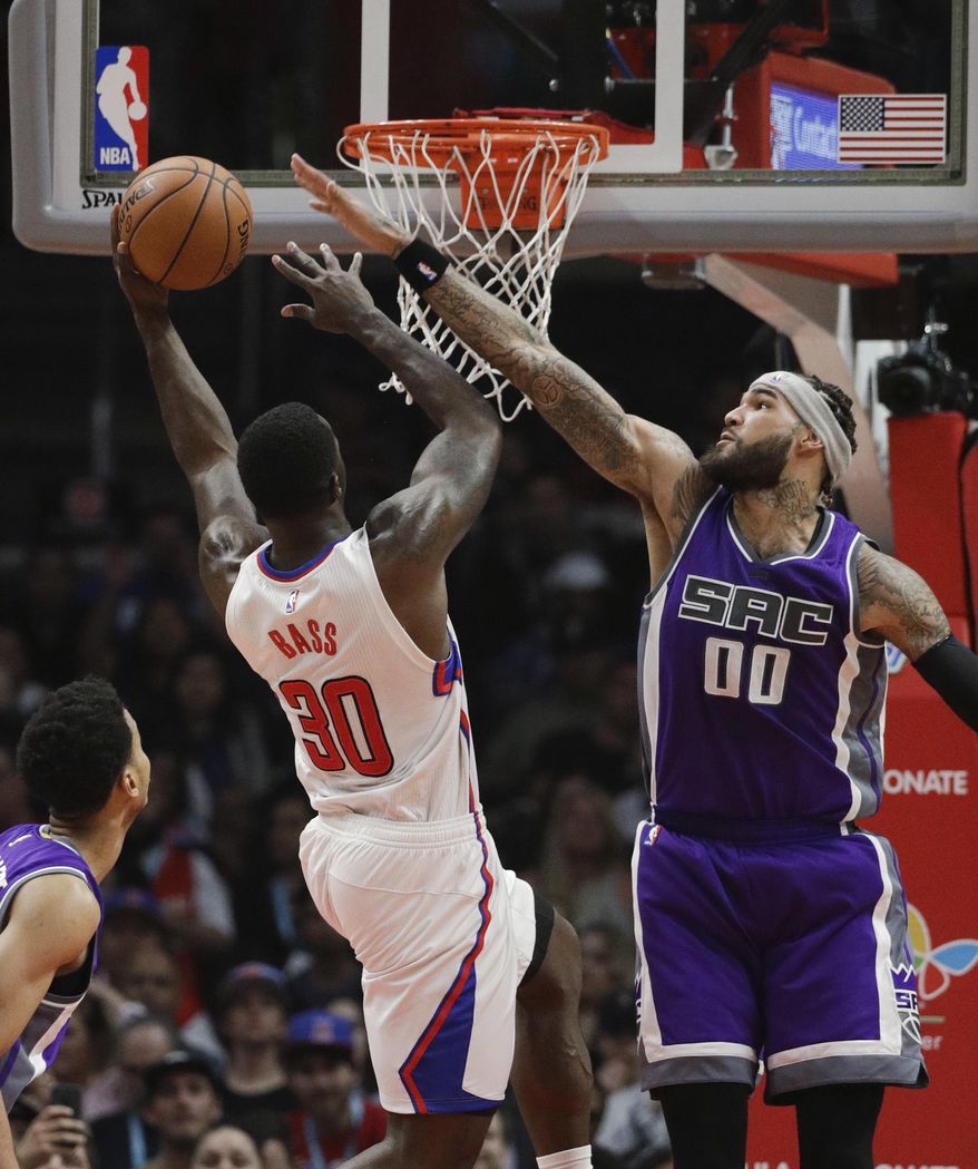 Los Angeles Clippers' Brandon Bass shoots against Sacramento Kings' Willie Cauley-Stein, right, during the first half of an NBA basketball game Wednesday, April 12, 2017, in Los Angeles. (AP Photo/Jae C. Hong)