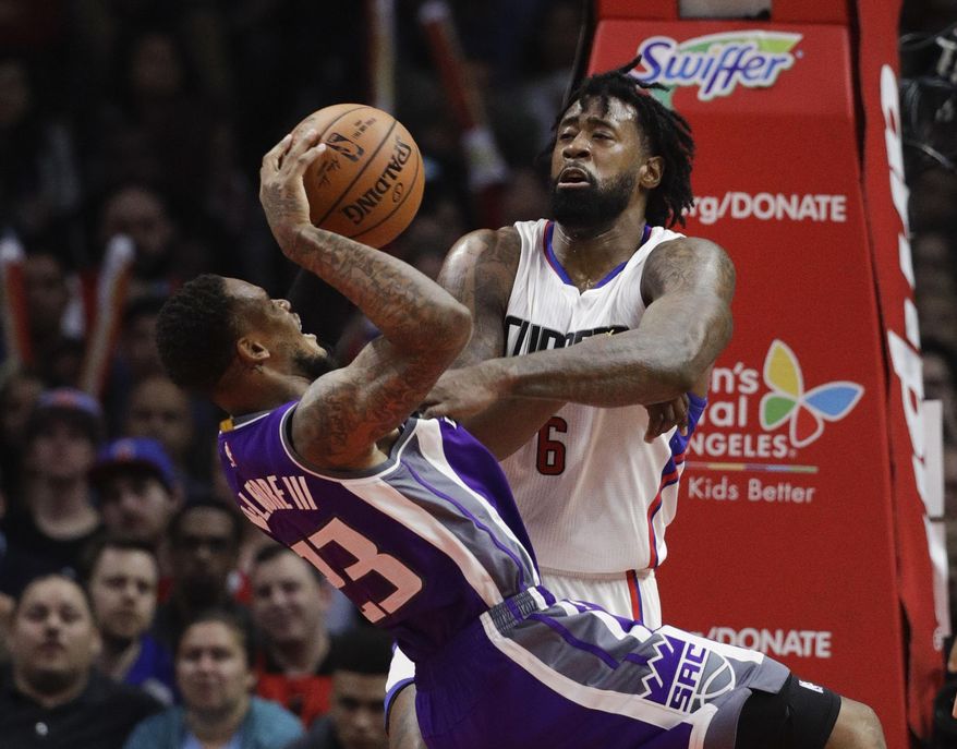 Sacramento Kings' Ben McLemore, left, is fouled by Los Angeles Clippers' DeAndre Jordan during the second half of an NBA basketball game Wednesday, April 12, 2017, in Los Angeles. The Clippers won 115-95. (AP Photo/Jae C. Hong)