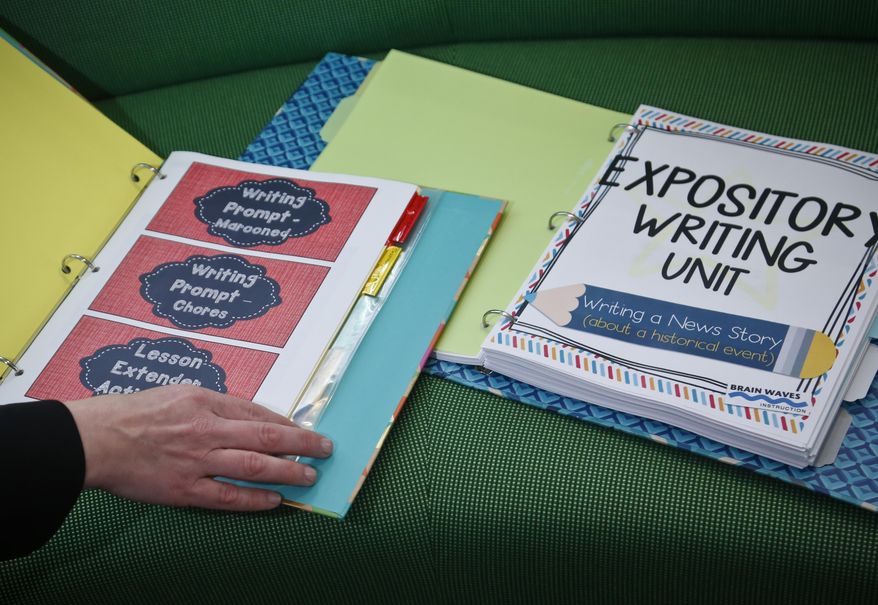 In this Monday April 3, 2017, photo, Mary Beth Nerone, a former middle-school teacher from Rochester, N.Y., display materials from her online store in New York. After losing her job as a language arts teacher to budget cuts three years ago, Nerone began stocking the store with writing, poetry and other curricula exercises she created for other teachers to purchase. (AP Photo/Bebeto Matthews)