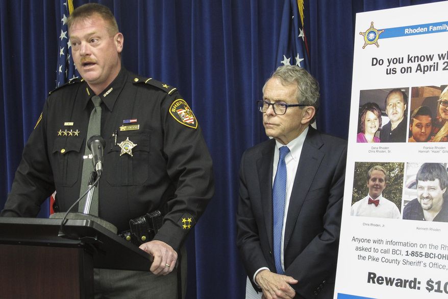 Pike County Sheriff Charles Reader, left, discusses the ongoing investigation into the unsolved killings of eight family members in southern Ohio on April 22, 2016, at a news conference attended by Attorney General Mike DeWine, whose office is leading the investigation, on Thursday, April 13, 2017, in Columbus, Ohio. Reader and DeWine both said they believe individuals may be holding back information out of fear of self-incrimination over their own, unrelated drug crimes. (AP Photo/Andrew Welsh-Huggins)